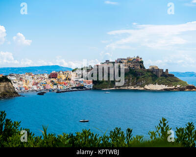View of the island of Procida with its colourful houses, harbour and the Marina di Corricella at the back of the mountain the Stock Photo