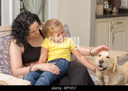 Mother and Daughter with Golden Retriever on Porch Stock Photo
