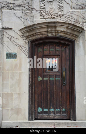 Arched wood door to a building on the University of Chicago campus. Stock Photo