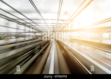 Light trail from moving train during evening Stock Photo