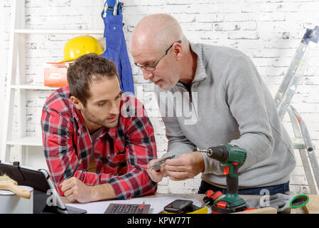 two technician examining  mechanical part Stock Photo