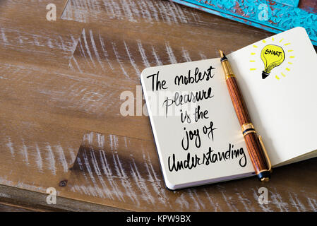 Handwritten text The noblest pleasure is the joy of understanding Stock Photo