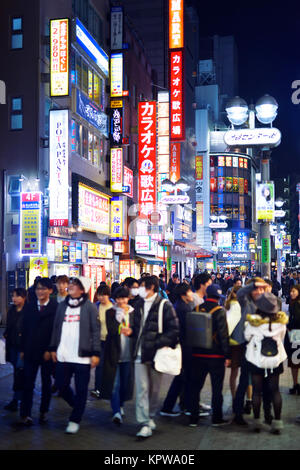 Young people at night in the streets of Tokyo, Shibuya, Udagawacho with shining colorful street lights and shop signs. Tokyo city night life, Japan 20 Stock Photo