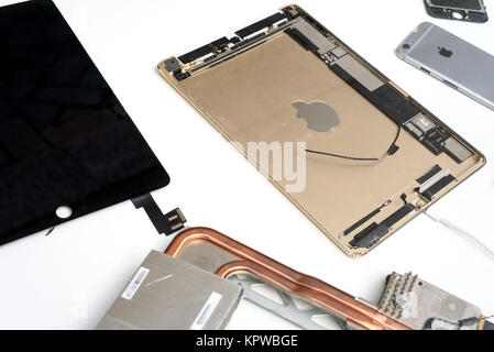 Broken components of an apple macbook ipad computer on a white background with a copyspace area for computer repair design ideas Stock Photo