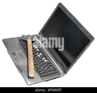 old defective laptop with hammer on keyboard Stock Photo