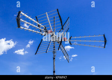 Tv antenna against blue sky Stock Photo