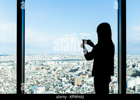 Silhouette of woman shooting photo Stock Photo