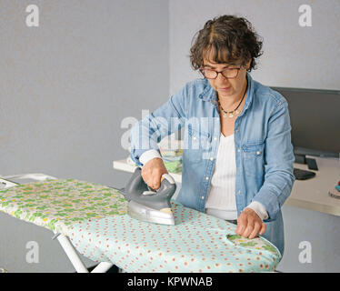 charming woman doing the ironing Stock Photo