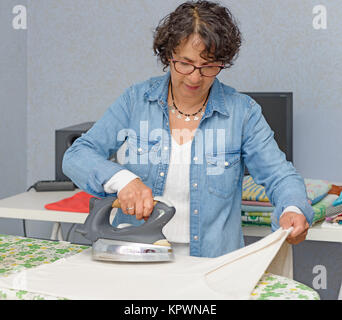 charming woman doing the ironing Stock Photo