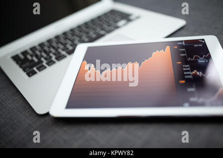 Analyzing stock market from digital tablet Stock Photo