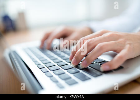 Female hands typing on laptop Stock Photo