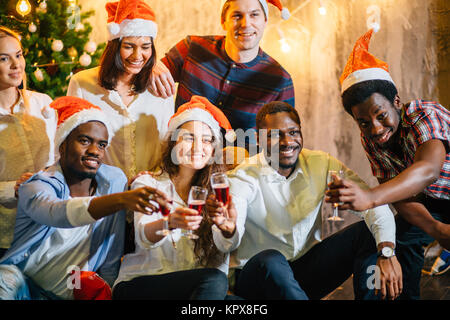 Friends Enjoying Christmas Drinks In Bar Stock Photo