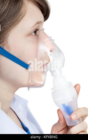 girl inhales with face mask of modern inhaler Stock Photo