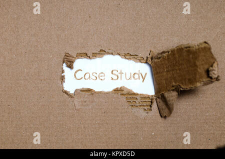 The word case study appearing behind torn paper. Stock Photo