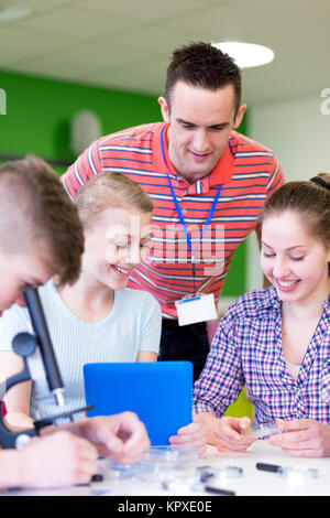 Experimenting with Microscopes in a Science Lesson Stock Photo