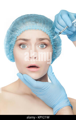 Attractive woman at plastic surgery with syringe in her face Stock Photo