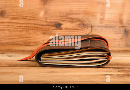 Notebook in leather cover on wooden table Stock Photo