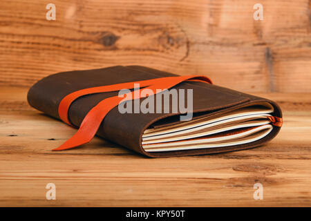 Notebook in leather cover on wooden table Stock Photo