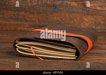 Notebook in leather cover on wooden table Stock Photo