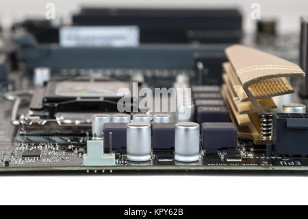 nodern closeup of computer motherboard with capacitors and resistors Stock Photo