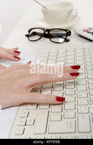 woman office worker typing on the keyboard Stock Photo