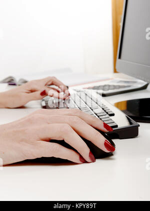 woman office worker typing on the keyboard Stock Photo
