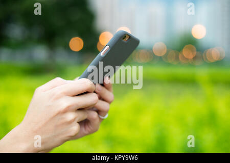 Woman use of mobile phone at outdoor Stock Photo