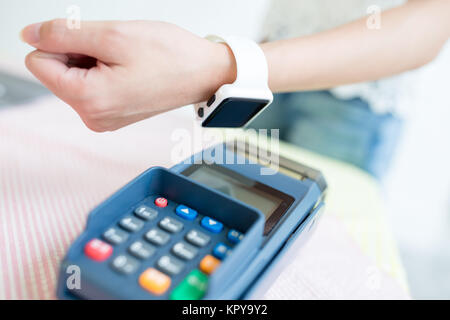 Customer paying through smart watch Stock Photo