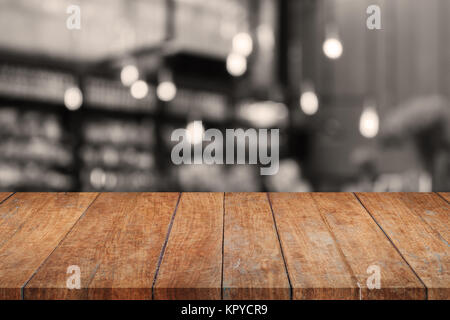 Wooden tabletop with sepia coffee shop blurred background Stock Photo