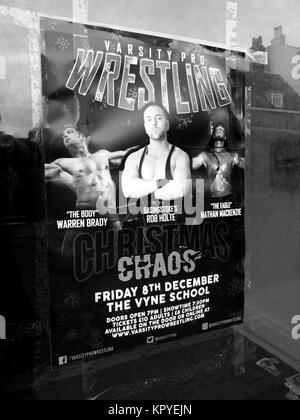 Varsity Pro Wrestling advertising poster taped to vacant shop window Stock Photo