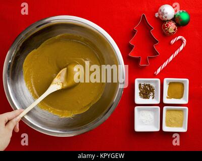 person holding spatula in chocolate syrup with cake ingredient Stock Photo