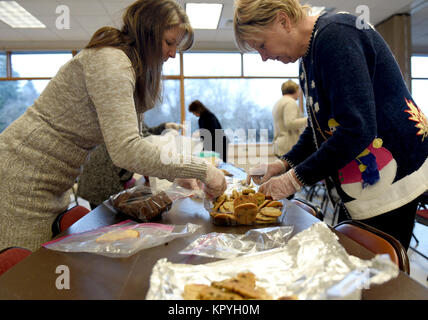 Members of the Officers’ Spouses’ Club and the Enlisted Spouses’ Club organize cookies for the annual Operation Cookie Drop at the base chapel Dec. 11, 2017, at Fairchild Air Force Base, Washington. The women worked to fill over 600 bags of cookies and treats for 92nd Air Refueling Wing and 336th Training Group Airmen living in the dorms with the intent of raising moral and holiday cheer. (U.S. Air Force Stock Photo