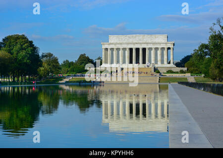 Landscape view of the Lincoln Memorial and reflection in the Reflecting Pool, Washington DC, USA on a sunny warm day with blue sky light clouds Stock Photo