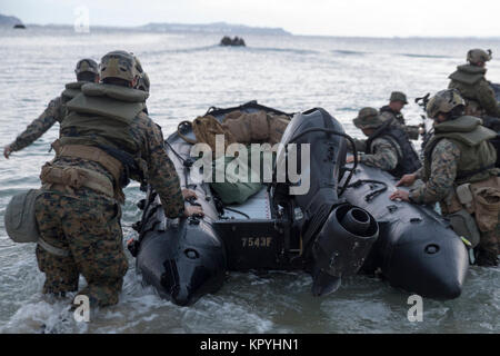Marines with Bravo Company, Battalion Landing Team, 1st Battalion, 1st Marines, conduct an amphibious assault during Marine Expeditionary Unit Exercise at Kin Blue, Okinawa, Japan, Dec. 12, 2017. Bravo Company specializes in amphibious assaults from the sea as part of BLT 1/1, which is the Ground Combat Element of the 31st MEU. MEUEX is the first in a series of pre-deployment training events that prepare the 31st MEU to deploy at a moment’s notice. As the Marine Corps' only continuously forward-deployed MEU, the 31st MEU provides a flexible force ready to perform a wide range of military opera Stock Photo