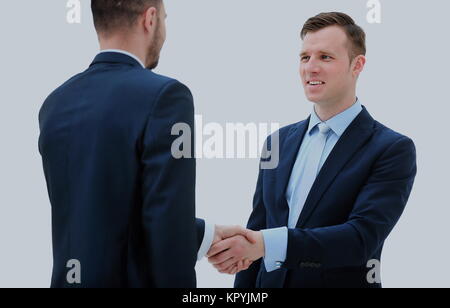 Business colleagues sitting at a table during a meeting with two male executives shaking hands Stock Photo