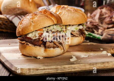 Homemade pulled pork burger with coleslaw salad and bbq sauce Stock Photo