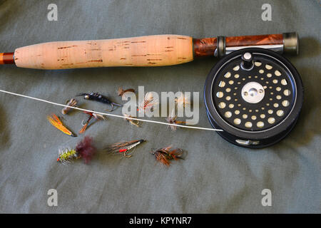 Custom bamboo fly rod, reel, line and an assortment of flies for trout  fishing on a green canvas background Stock Photo - Alamy