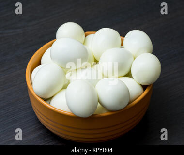 Bunch of boiled and peeled eggs in a bowl. Concept of food and organic farm products. Stock Photo