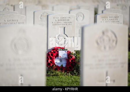 Poppy wreath at the grave of A. Robinson from New Zealand on the Tyne Cot military cemetery in Zonnebeke, Belgium. Stock Photo