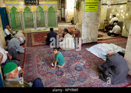 Yazd, Iran - April 21, 2017: Shrine of Prince Fazel, Prayer hall of Sahhzade Fazel Holy Shrine, muslims pray. Stock Photo