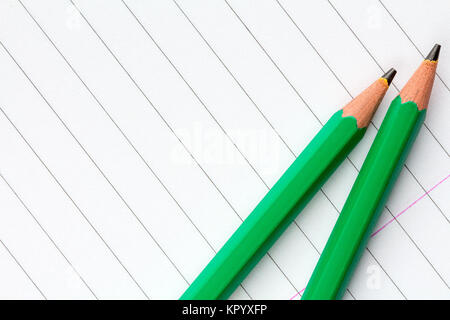 Green Pencils on Lined Paper Stock Photo