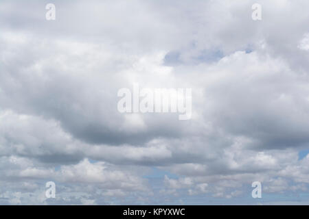 Fluffy soft white cloud formations showing just a small amount a pale blue sky behind it. The type that might mean rain, but doesn't look cold or broo Stock Photo