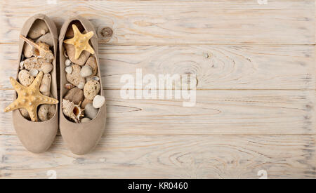 Women's shoes beige color on a wooden background. Selective focus. Stock Photo