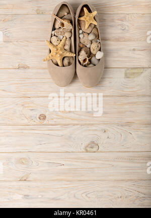 Women's shoes beige color on a wooden background. Selective focus. Stock Photo