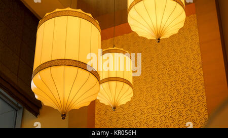 Yellow, orange paper lamp traditional lanna style. Traditional Nepalese, Chenese or Asian lamp under the ceiling Stock Photo
