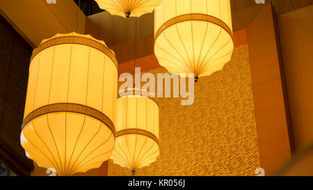 Yellow, orange paper lamp traditional lanna style. Traditional Nepalese, Chenese or Asian lamp under the ceiling Stock Photo