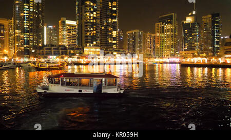 The night illumination of Dubai Marina and Dhow boat in Dubai, UAE. It is an artificial canal city. Motor boat, beautiful night city landscape background Stock Photo