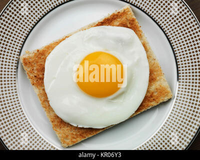 Healthy Breakfast Food or Snack of a Single Fried Egg on Toast Stock Photo