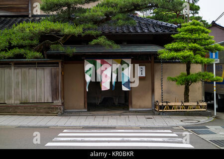 Kanazawa - Japan, June 10, 2017: Entrance to a restaurant with colorful curtains and trees in shape Stock Photo