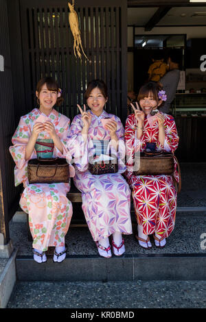 Kanazawa - Japan, June 11, 2017: Women in kimono eating a snack in the historical Higashi Chaya District, Kanazawa City, Ishikawa Prefecture Stock Photo
